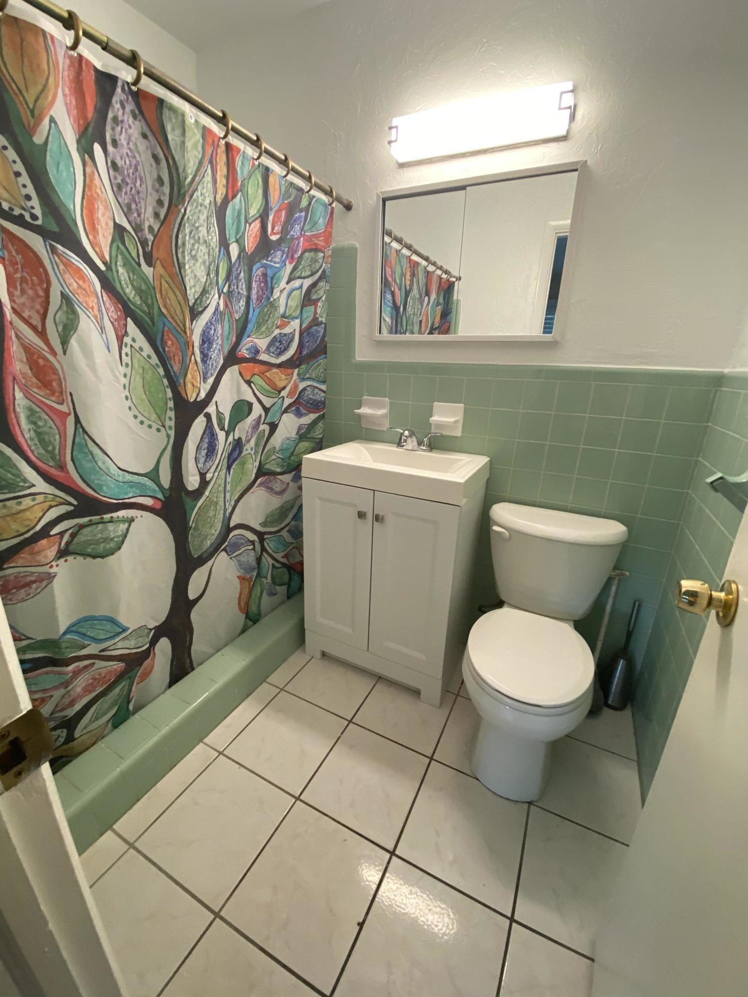1711 High Ridge Road Lake Worth, FL 33461 - Photo 8 of 14 a bathroom with a toilet and a sink