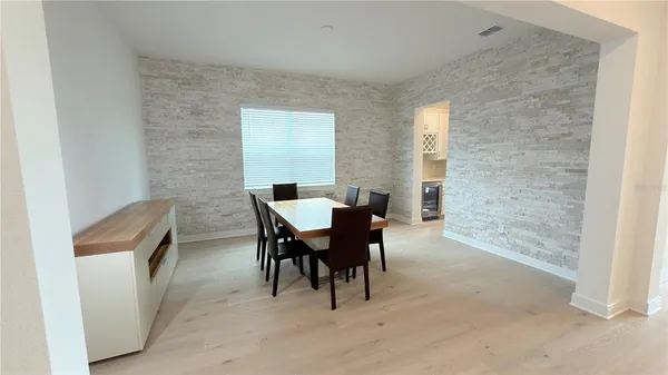 a kitchen with a wooden floor and cabinets
