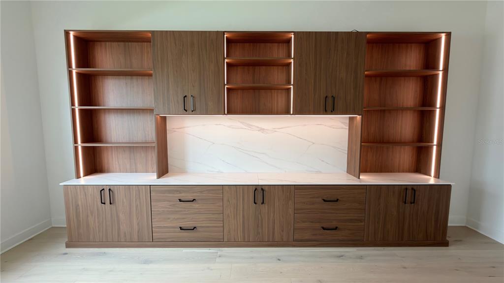15295 Rising Vw Drive Montverde, FL 34756 - Photo 15 of 50 a kitchen with a wooden floor and cabinets