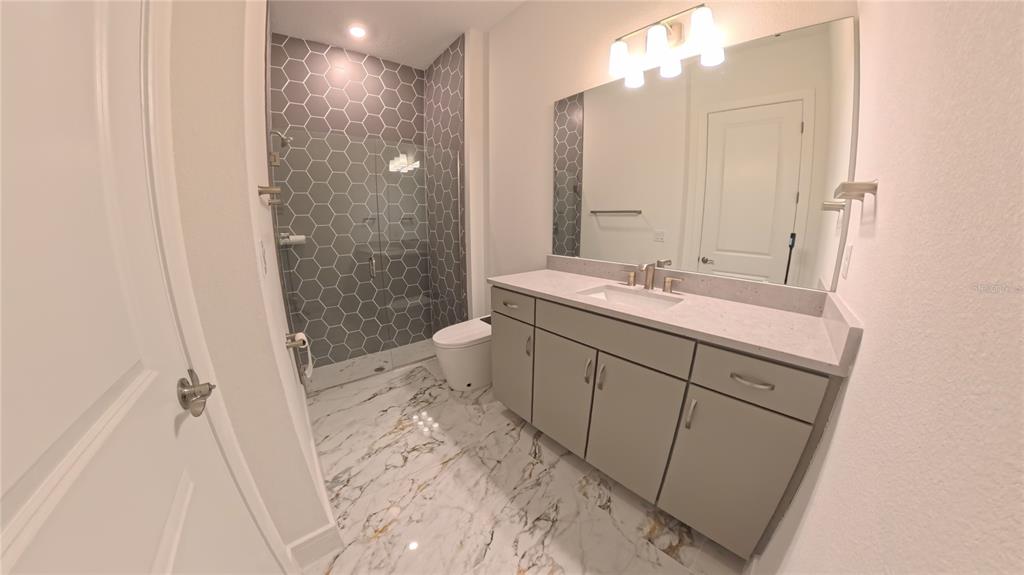15295 Rising Vw Drive Montverde, FL 34756 - Photo 17 of 50 a bathroom with a sink a toilet and shower