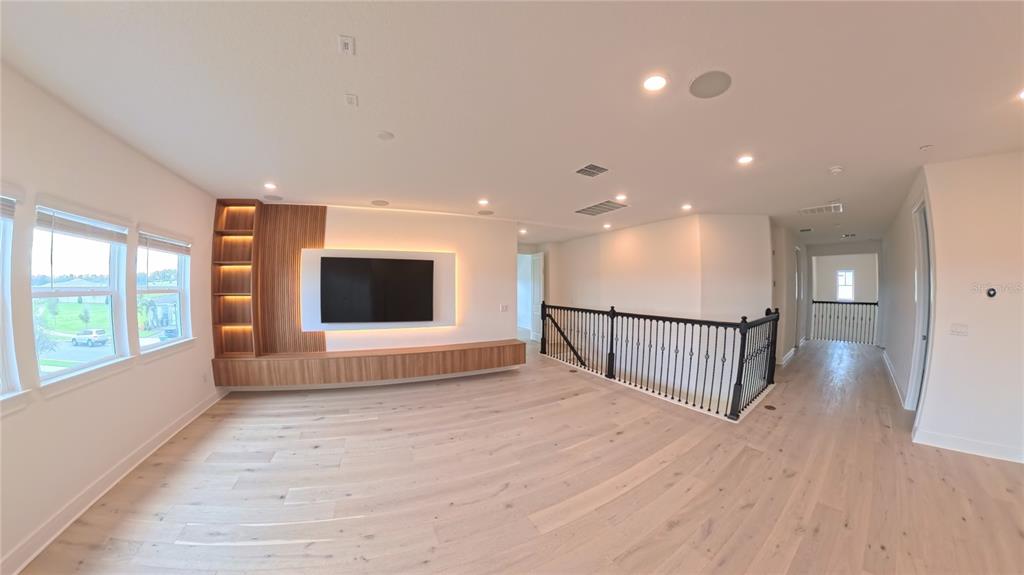 15295 Rising Vw Drive Montverde, FL 34756 - Photo 18 of 50 a view of an empty room with wooden floor and a window