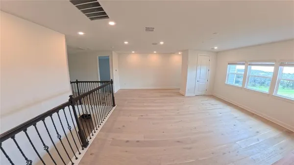 a view of hallway with furniture and a large window