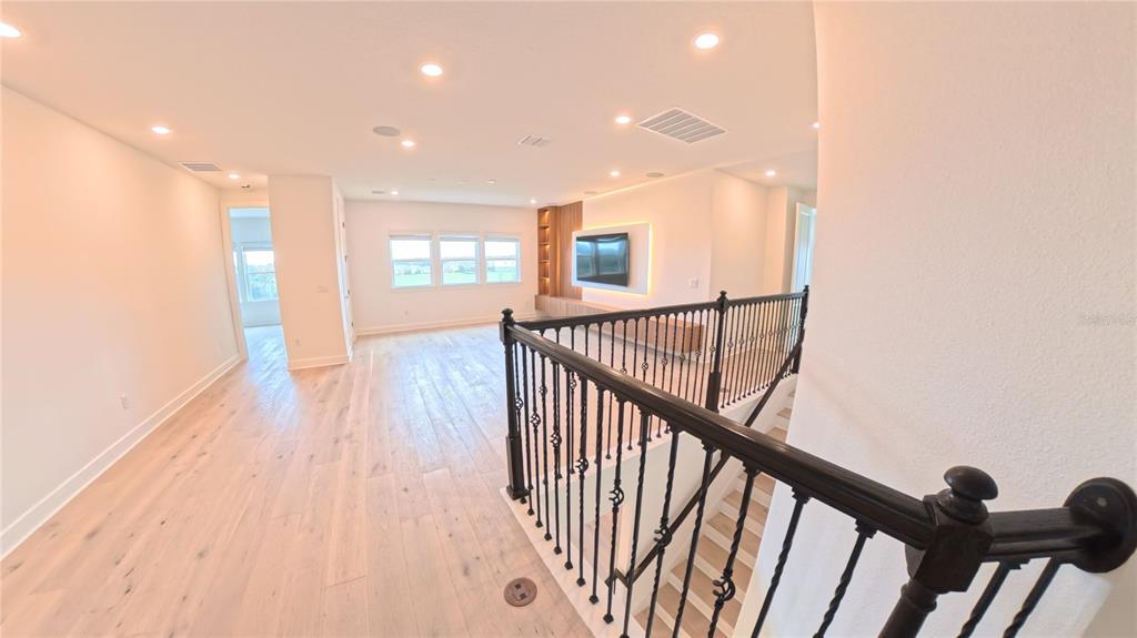 15295 Rising Vw Drive Montverde, FL 34756 - Photo 20 of 50 a view of a hallway with wooden floor and stairs