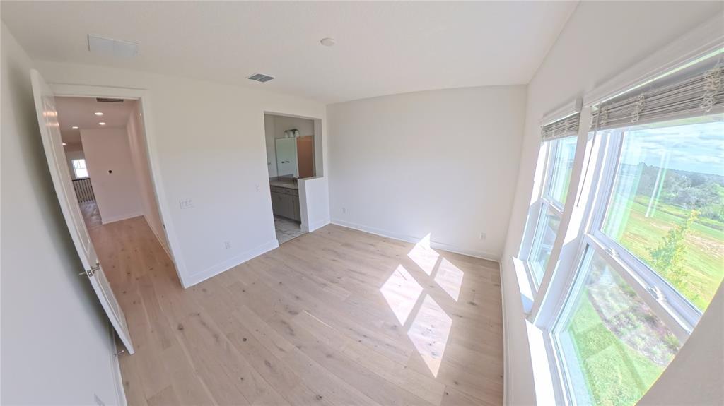 15295 Rising Vw Drive Montverde, FL 34756 - Photo 27 of 50 wooden floor in an empty room with a window
