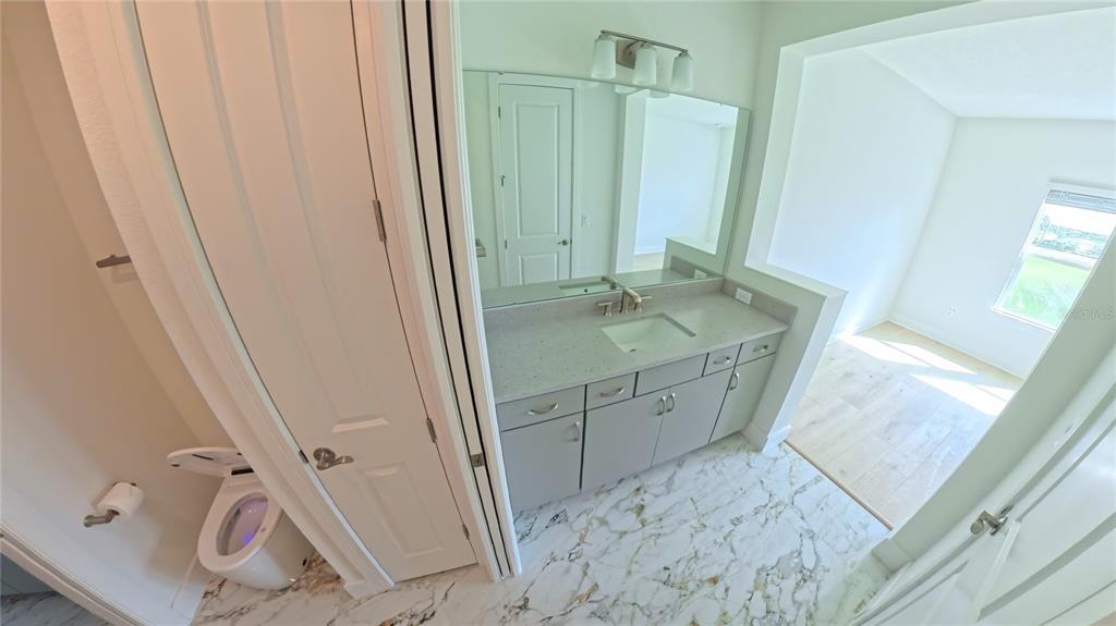 15295 Rising Vw Drive Montverde, FL 34756 - Photo 31 of 50 a bathroom with a sink and mirror with bathtub