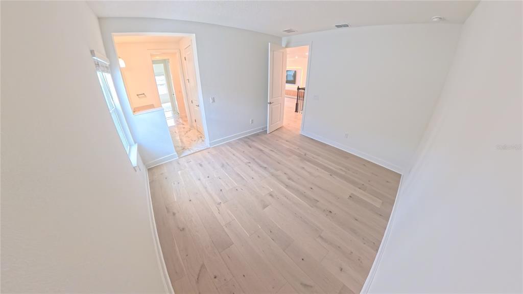 15295 Rising Vw Drive Montverde, FL 34756 - Photo 32 of 50 a view of an empty room with wooden floor and a window