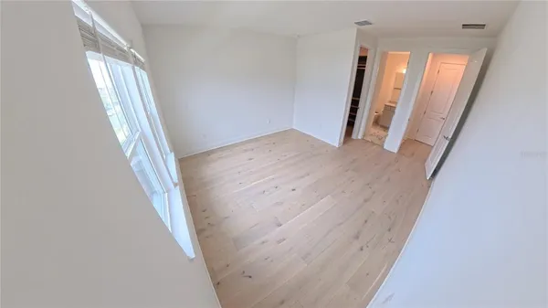 view of a room with wooden floor and windows