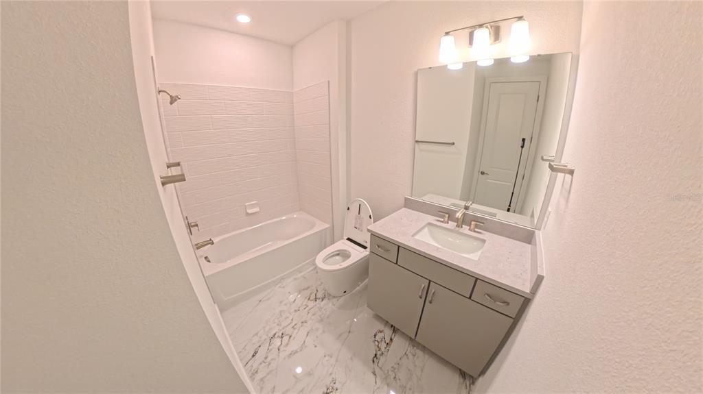 15295 Rising Vw Drive Montverde, FL 34756 - Photo 35 of 50 a bathroom with a granite countertop sink toilet and shower
