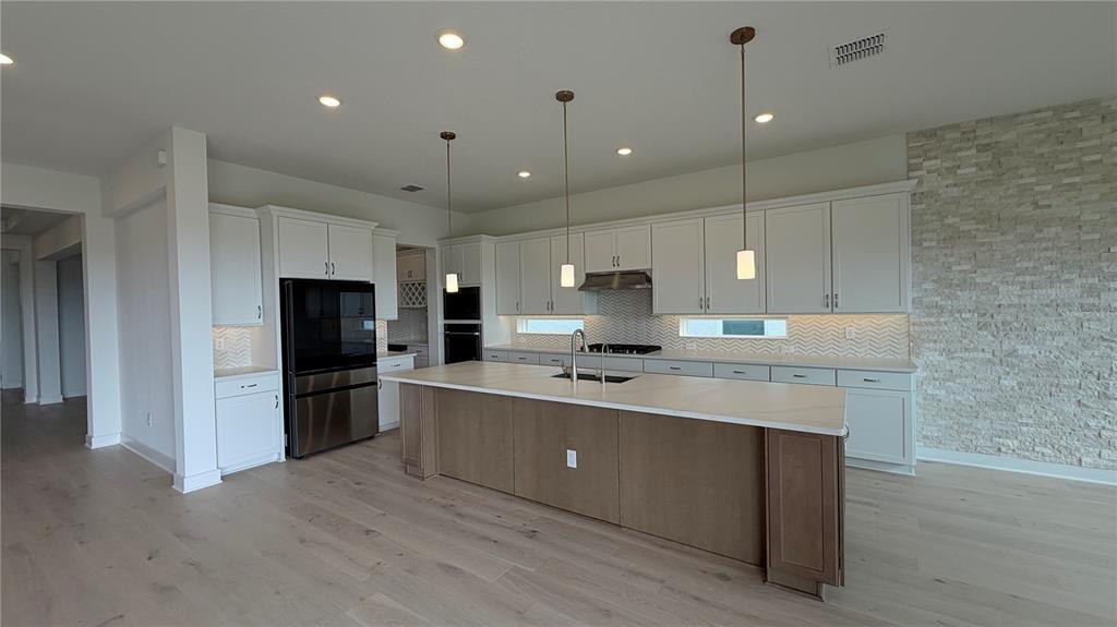 15295 Rising Vw Drive Montverde, FL 34756 - Photo 10 of 50 a large kitchen with kitchen island a sink stainless steel appliances and cabinets