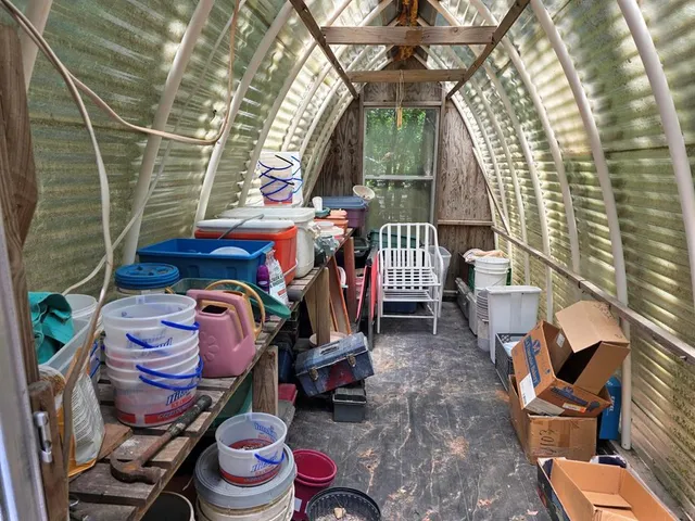 a view of a wooden house with a small yard