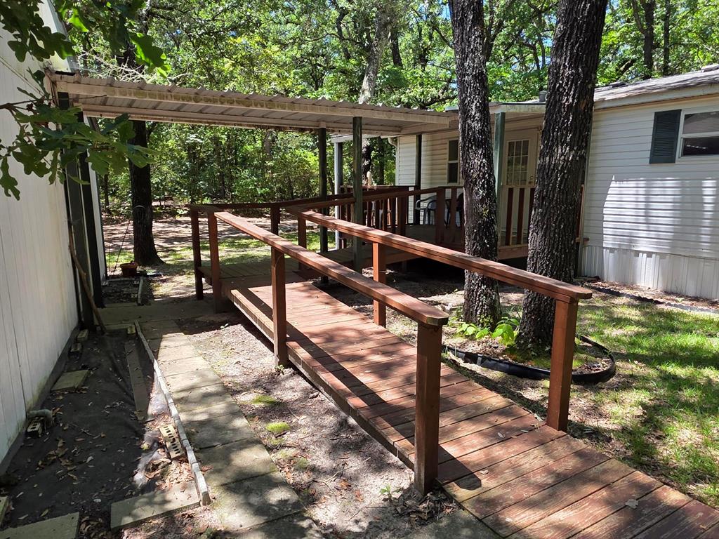 3872 East State Highway 154 Quitman, TX 75783 - Photo 11 of 40 a view of balcony with wooden floor and outdoor seating