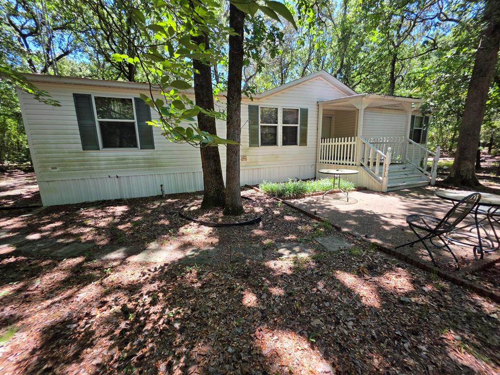 3872 East State Highway 154 Quitman, TX 75783 - Photo 21 of 40 a front view of a house with a yard