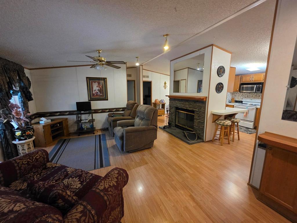 3872 East State Highway 154 Quitman, TX 75783 - Photo 24 of 40 a living room with furniture flat screen tv and fireplace