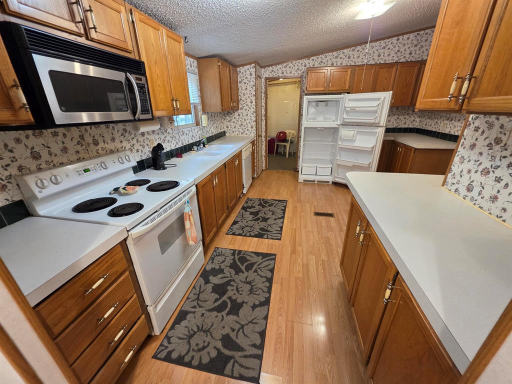 3872 East State Highway 154 Quitman, TX 75783 - Photo 30 of 40 a kitchen with a stove a sink and a microwave