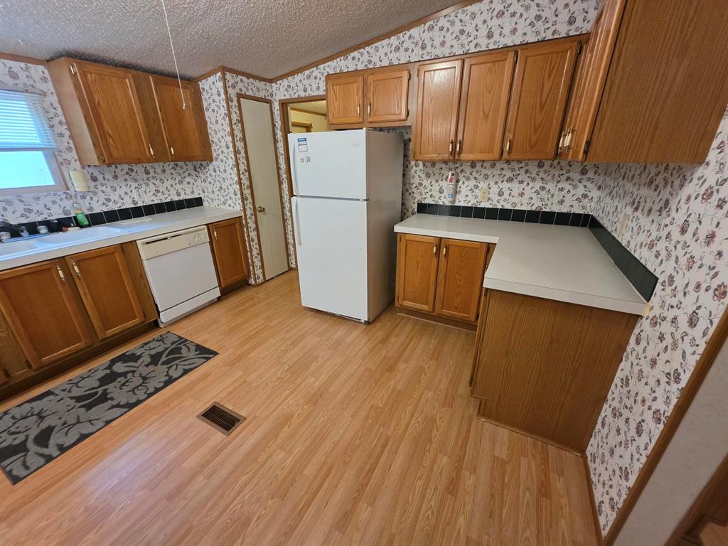3872 East State Highway 154 Quitman, TX 75783 - Photo 31 of 40 a kitchen with wooden floor and a sink