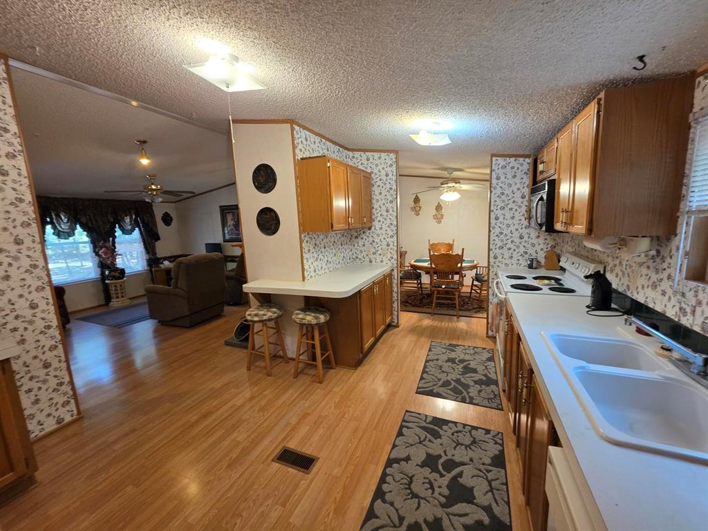3872 East State Highway 154 Quitman, TX 75783 - Photo 40 of 40 a large hall with stainless steel appliances lots of counter space and wooden floor