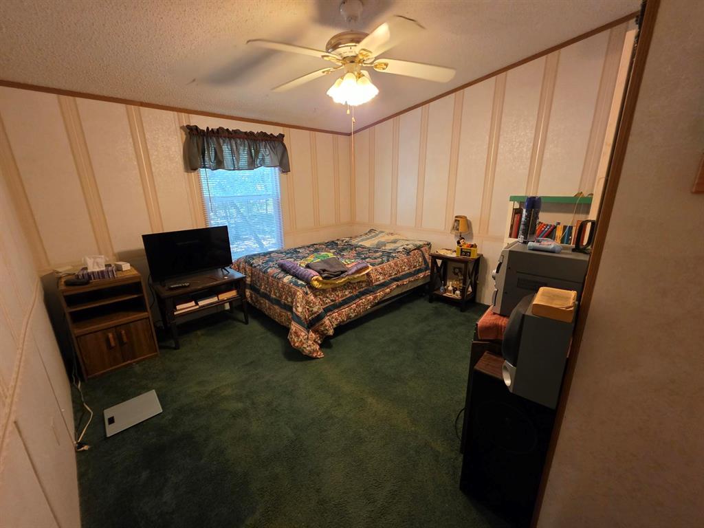 3872 East State Highway 154 Quitman, TX 75783 - Photo 36 of 40 a living room with furniture and a flat screen tv