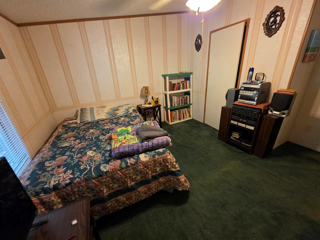 3872 East State Highway 154 Quitman, TX 75783 - Photo 37 of 40 a bed sitting in a room next to a window