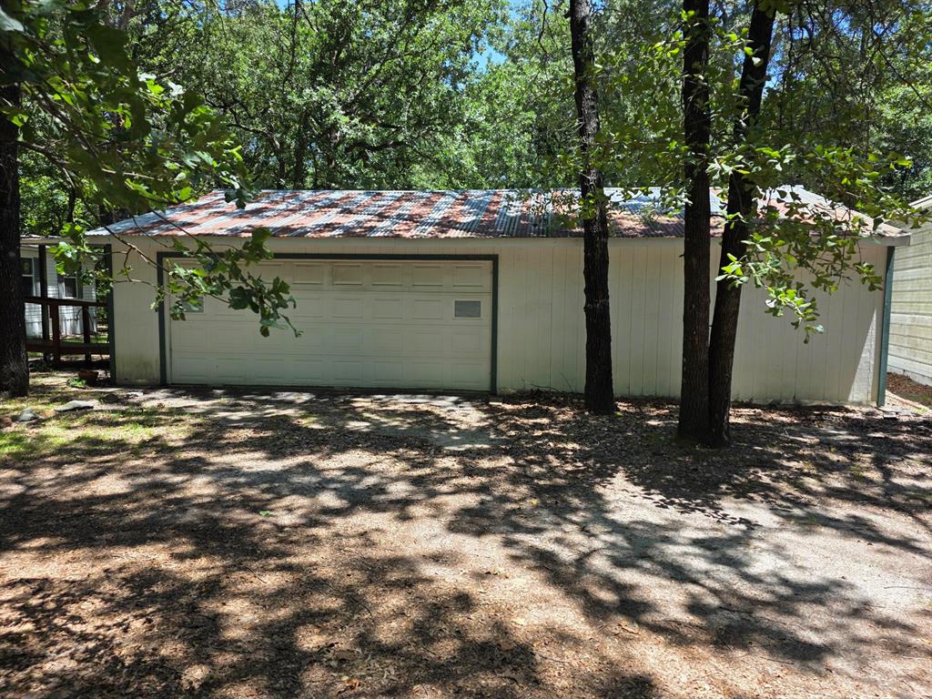 3872 East State Highway 154 Quitman, TX 75783 - Photo 8 of 40 a view of a wooden house with a tree