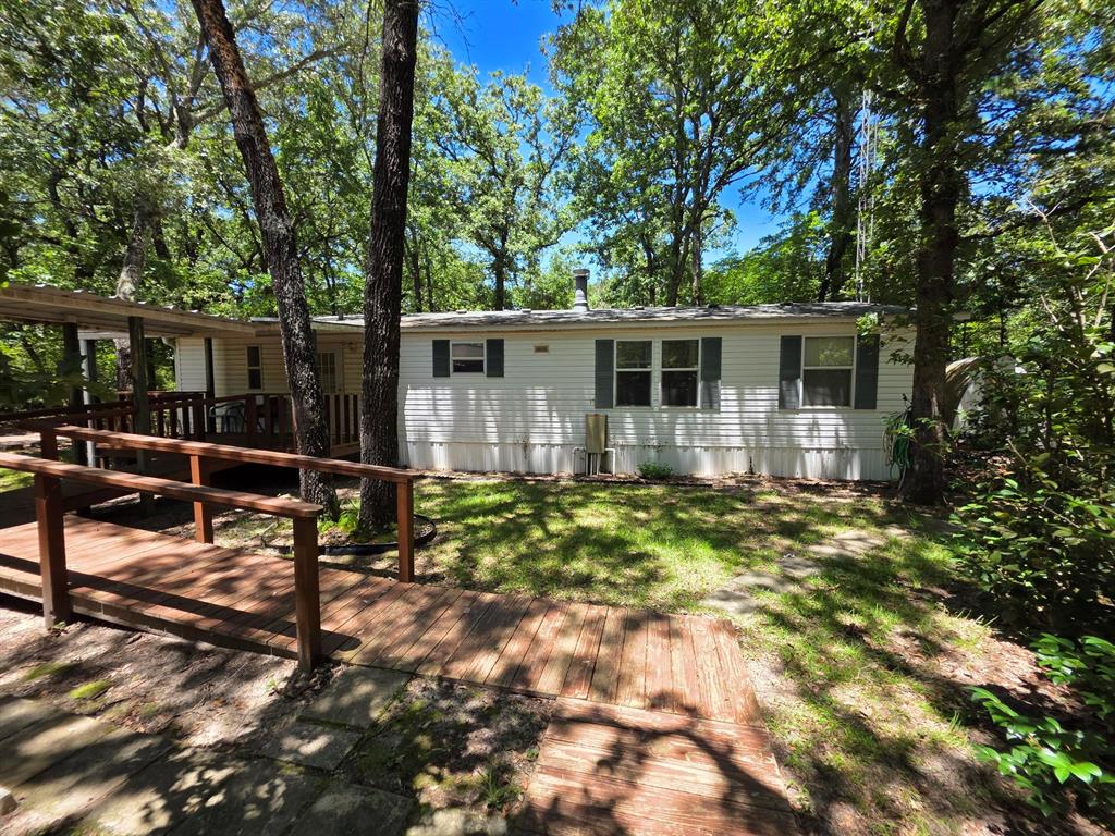 3872 East State Highway 154 Quitman, TX 75783 - Photo 10 of 40 a view of a house with backyard and sitting area