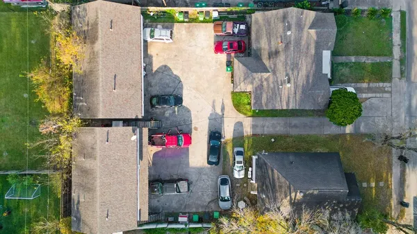 an aerial view of residential houses with outdoor space