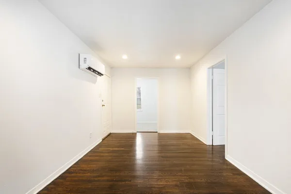 a view of room with wooden floor