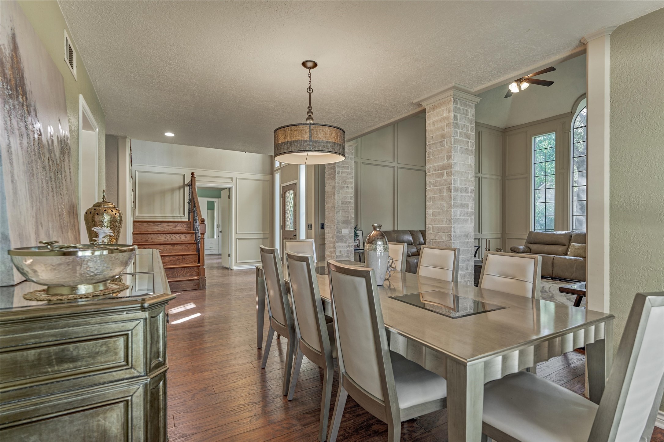 25706 Overlake Drive Spring, TX 77380 - Photo 10 of 32 This elegant dining flows into a cozy living space, allowing natural light to enhance the warm wood flooring and sophisticated decor.
