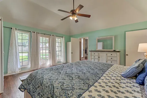 a bedroom with a large bed and a chandelier