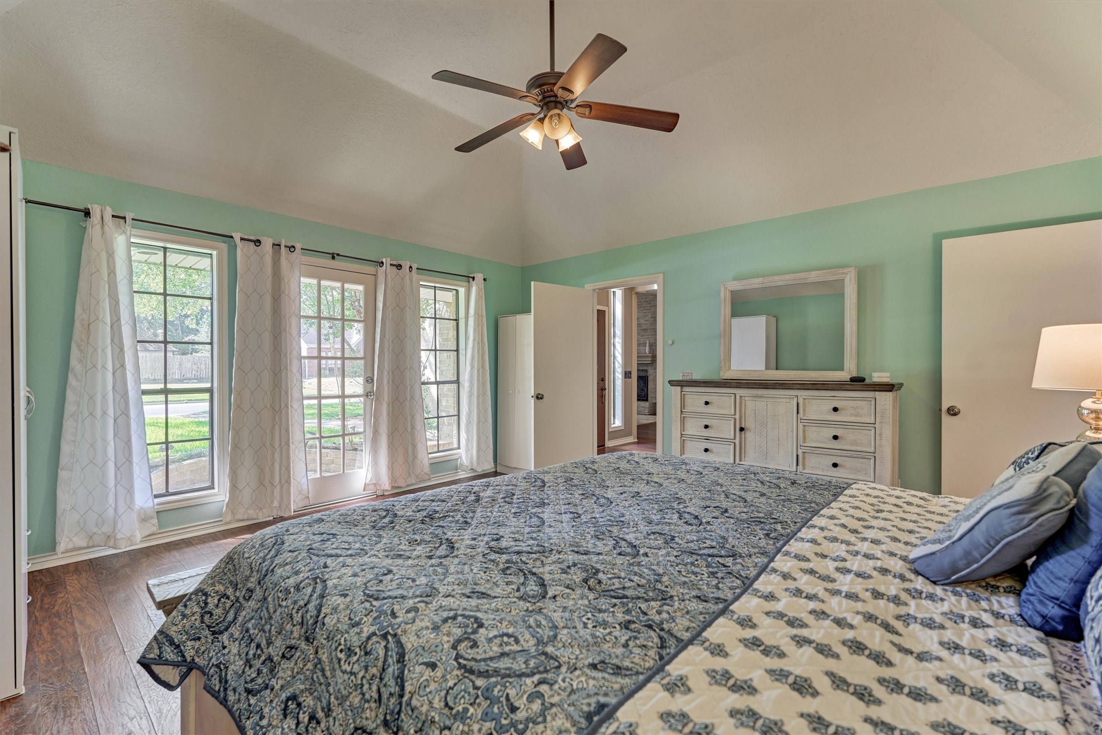 25706 Overlake Drive Spring, TX 77380 - Photo 16 of 32 Bright Primary bedroom with abundant natural light streaming through three large windows.