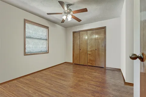 a spacious bathroom with a granite countertop sink mirror and a toilet