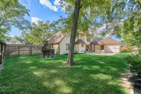 a view of a patio with table and chairs under an umbrella