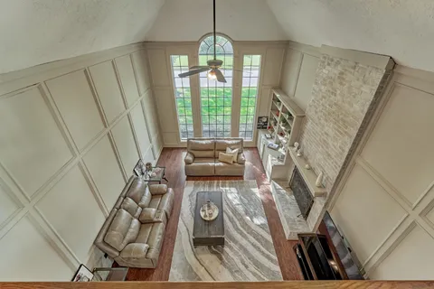 a view of empty room with wooden floor and floor to ceiling window