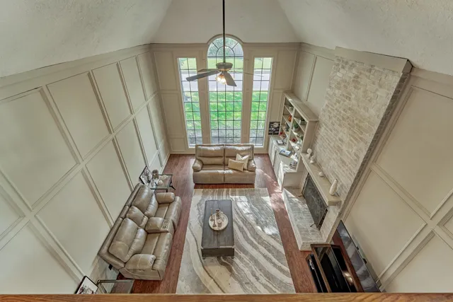 a view of empty room with wooden floor and floor to ceiling window