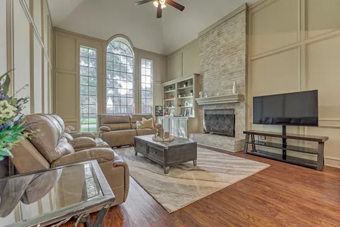 a living room with furniture and a floor to ceiling window