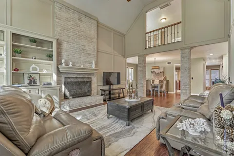 a living room with furniture fireplace and flat screen tv