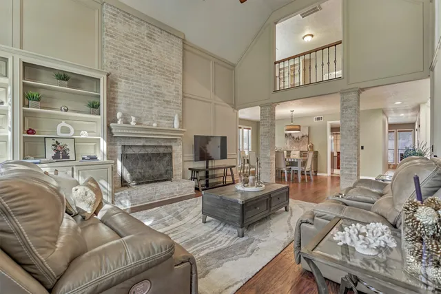 a living room with furniture fireplace and flat screen tv