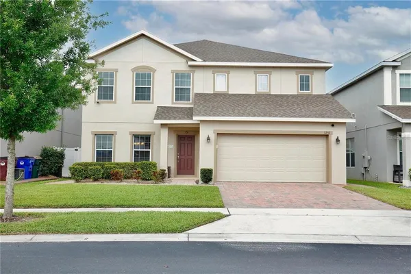 a front view of a house with a yard and garage