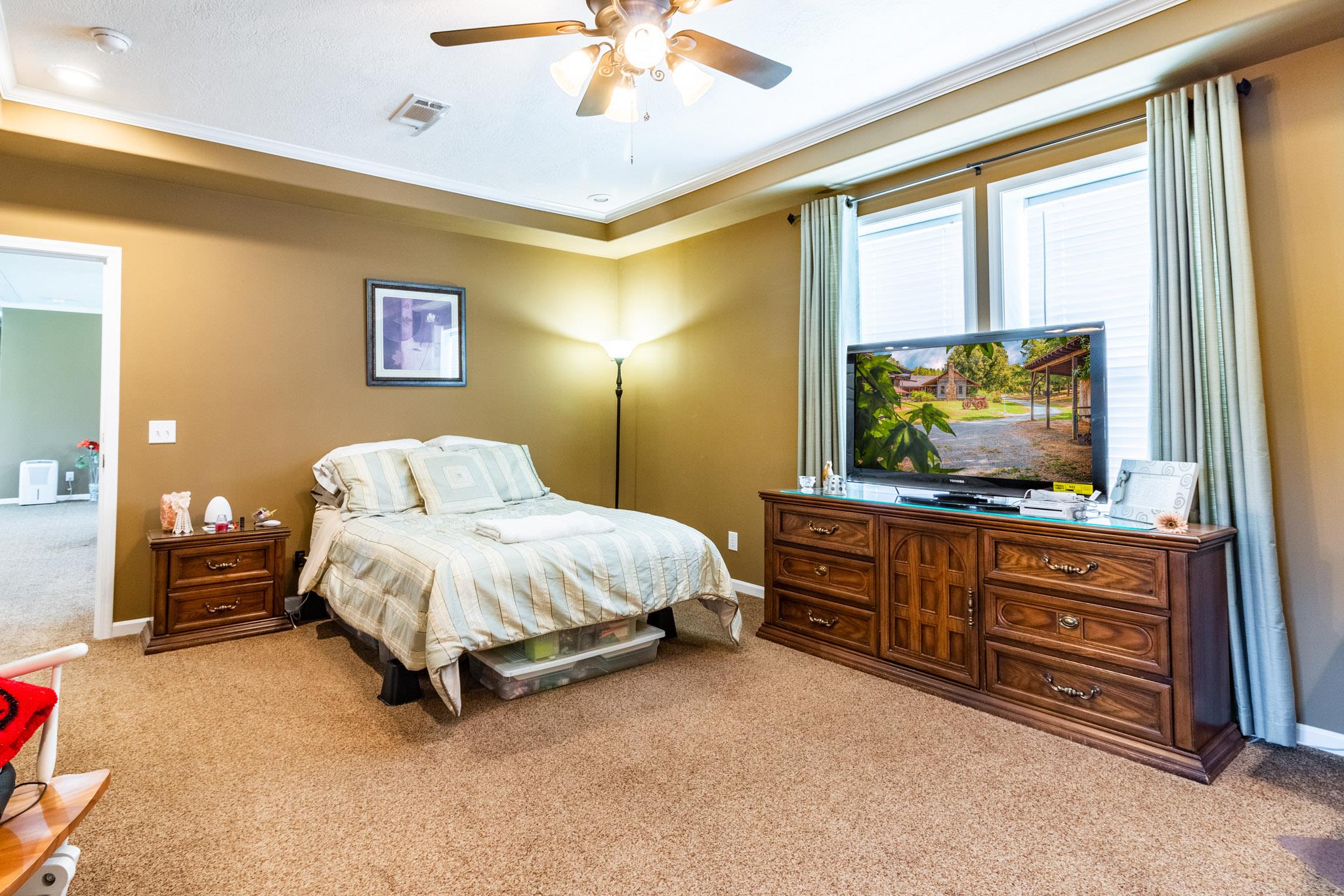 588 York Hollow Road Pulaski, TN 38478 - Photo 8 of 16 a spacious bedroom with a bed and a flat screen tv