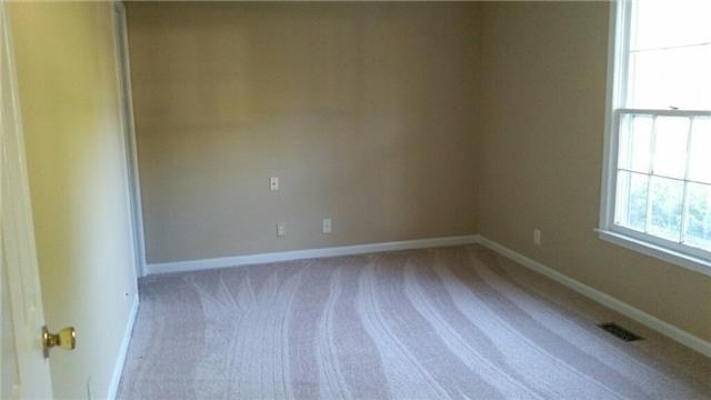 174 Excell Road Clarksville, TN 37043 - Photo 5 of 10 a view of an empty room with wooden floor and a window