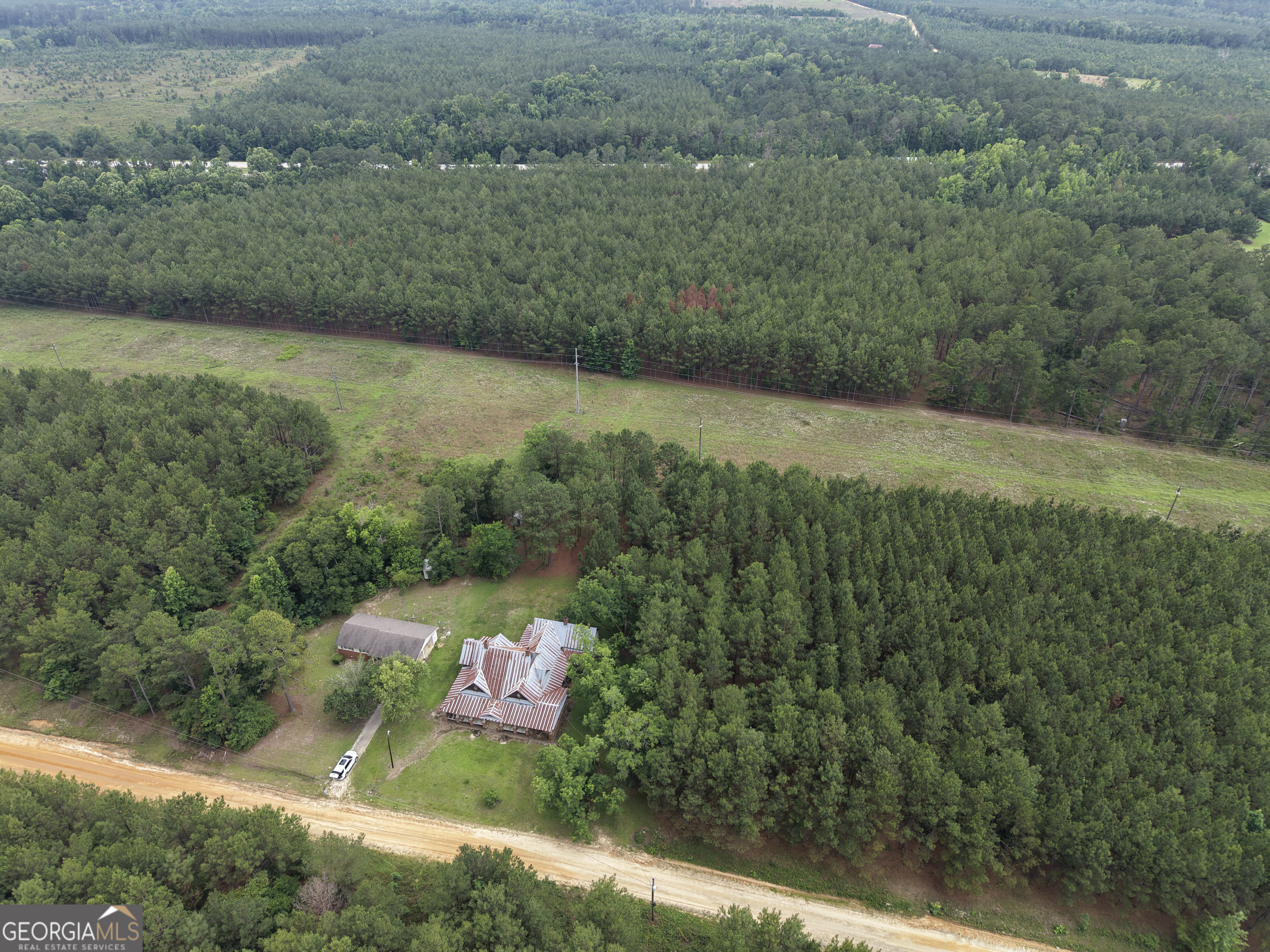 1869 Minter Blue Springs Road Rockledge, GA 30454 - Photo 7 of 45 a view of a lush green forest with a lake