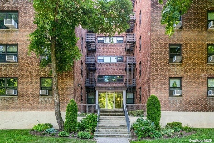 75-05 210th Street, Unit 2P Queens, NY 11364 - Photo 1 of 20 a front view of a house with a yard