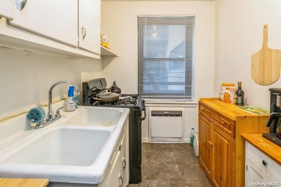 75-05 210th Street, Unit 2P Queens, NY 11364 - Photo 11 of 20 a kitchen with a sink stove and cabinets