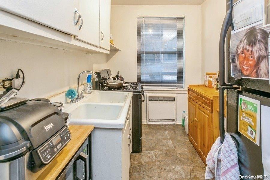 75-05 210th Street, Unit 2P Queens, NY 11364 - Photo 12 of 20 a utility room with sink dryer and washer