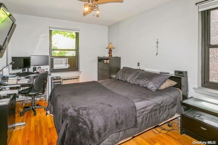 75-05 210th Street, Unit 2P Queens, NY 11364 - Photo 13 of 20 a bedroom with a bed and a window