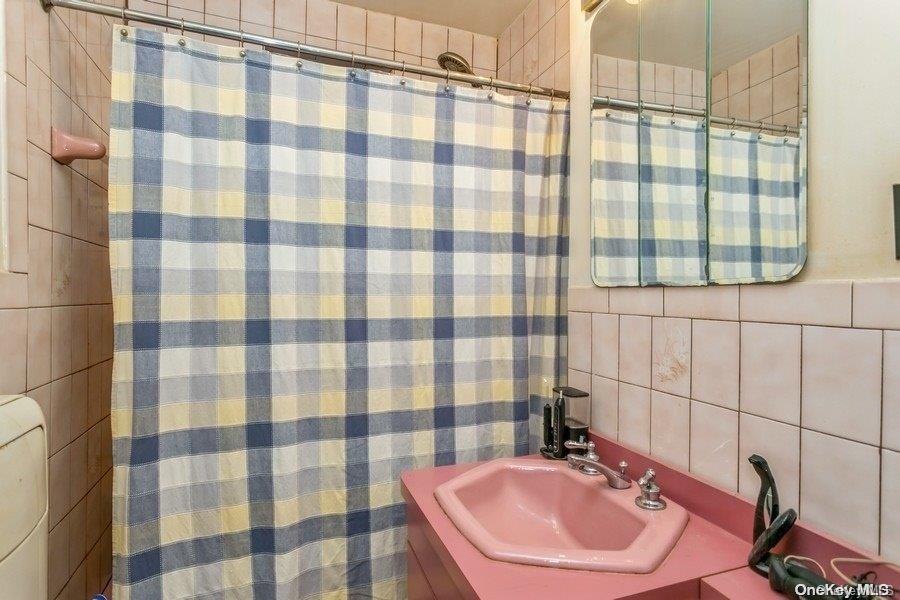 75-05 210th Street, Unit 2P Queens, NY 11364 - Photo 14 of 20 a bathroom with a sink and a mirror
