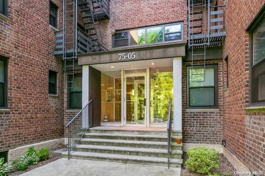 75-05 210th Street, Unit 2P Queens, NY 11364 - Photo 17 of 20 a view of a brick house with large windows