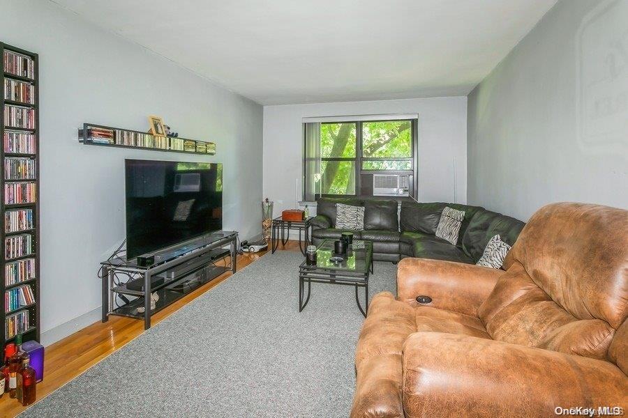 75-05 210th Street, Unit 2P Queens, NY 11364 - Photo 4 of 20 a living room with furniture and a flat screen tv