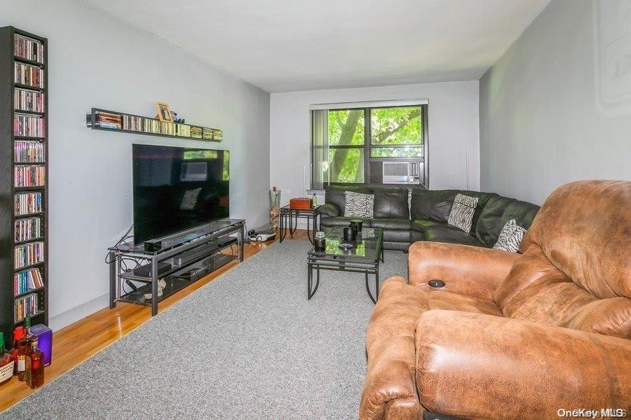 75-05 210th Street, Unit 2P Queens, NY 11364 - Photo 5 of 20 a living room with furniture and a flat screen tv