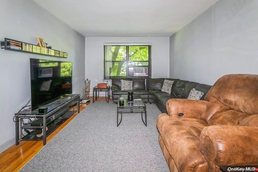 75-05 210th Street, Unit 2P Queens, NY 11364 - Photo 6 of 20 a living room with furniture and a flat screen tv