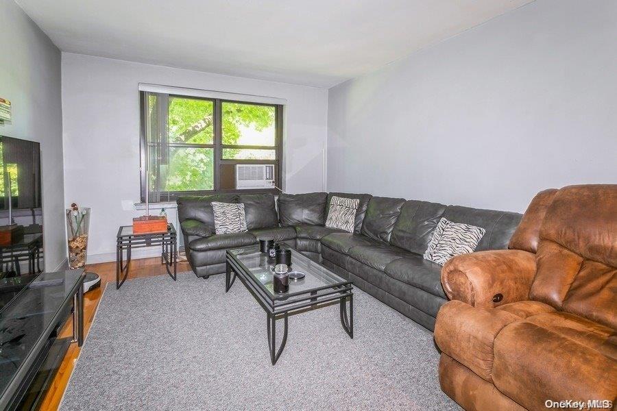 75-05 210th Street, Unit 2P Queens, NY 11364 - Photo 7 of 20 a living room with furniture and a window